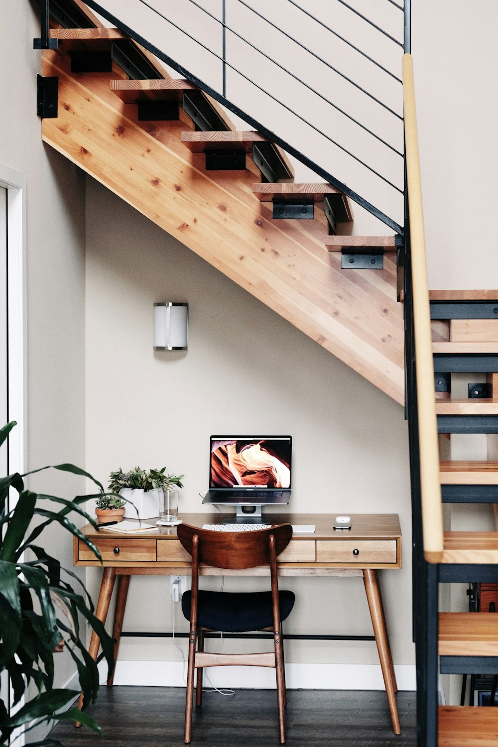 black flat screen tv turned on near brown wooden table