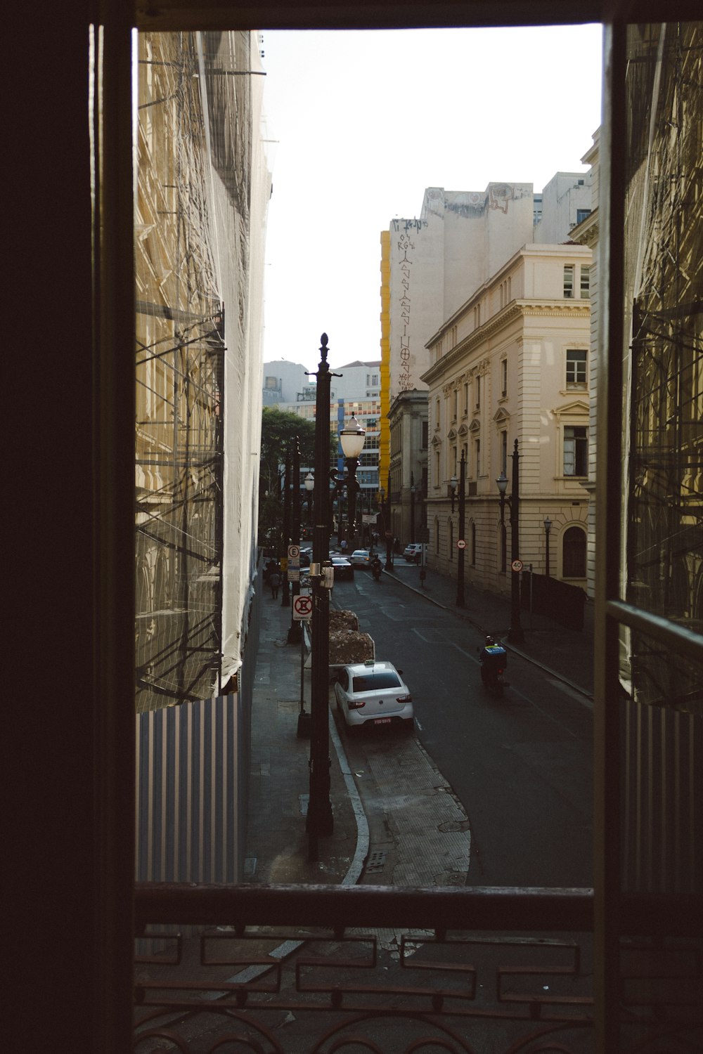 cars parked on sidewalk near buildings during daytime