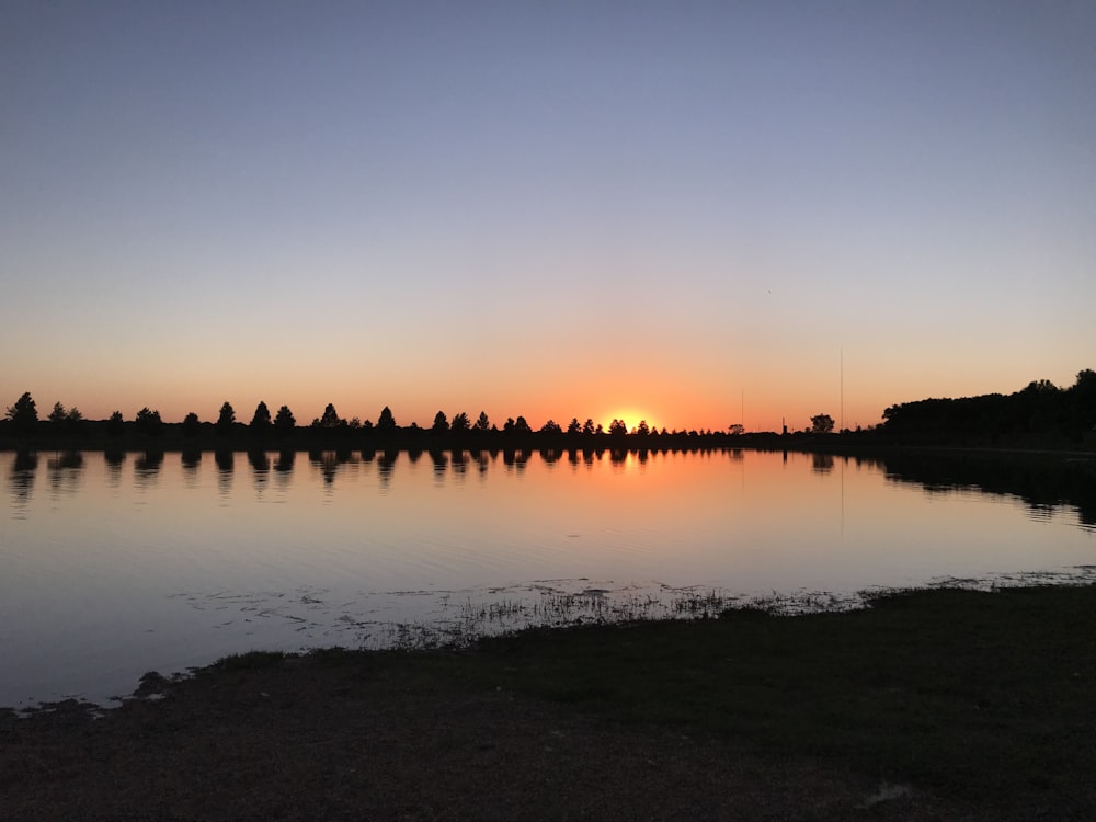 body of water during sunset