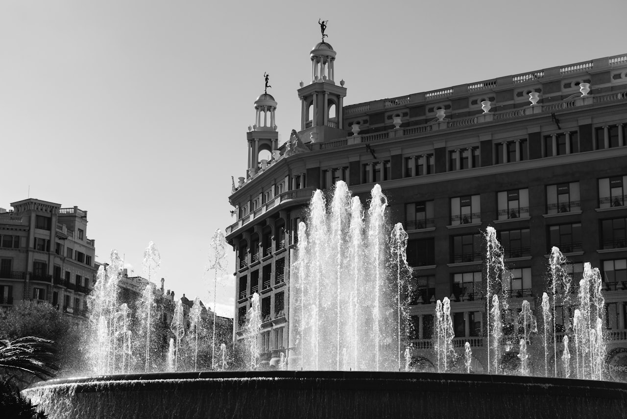 Plaza de Cataluña water fountain in front of brown concrete building during daytime