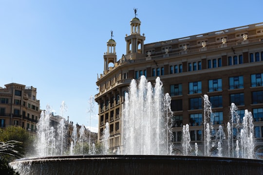 water fountain in front of brown concrete building during daytime in Plaza de España Spain