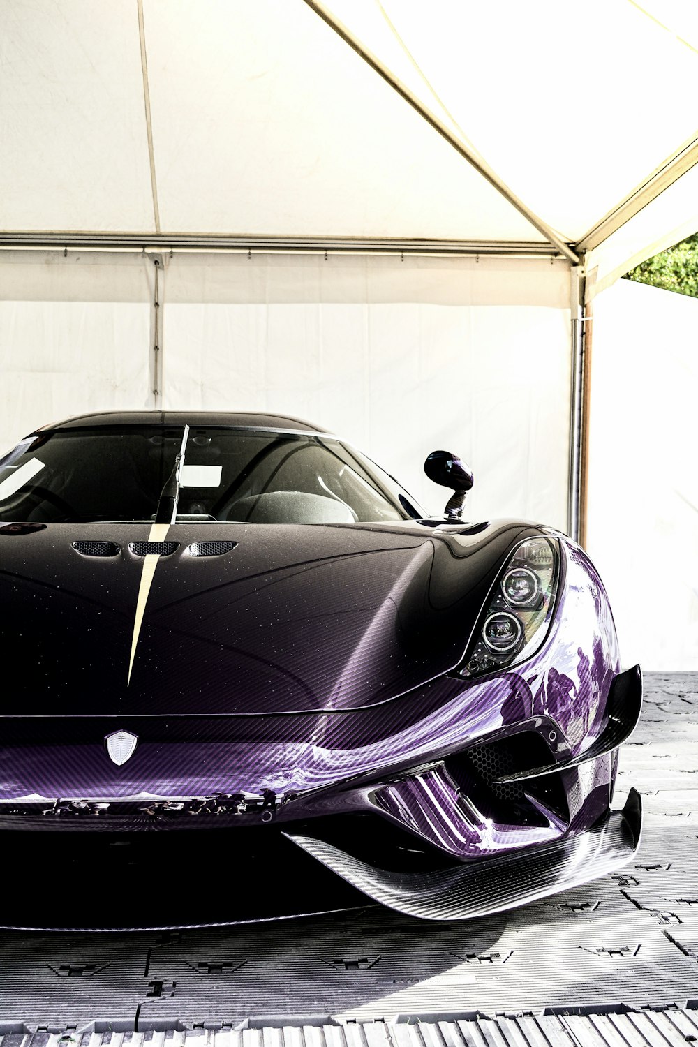 purple ferrari sports car in a garage