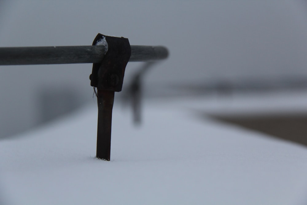 black metal pipe on snow covered ground