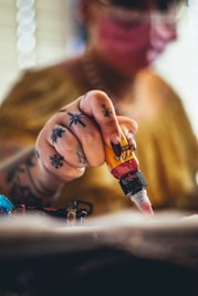 person holding brown glass bottle