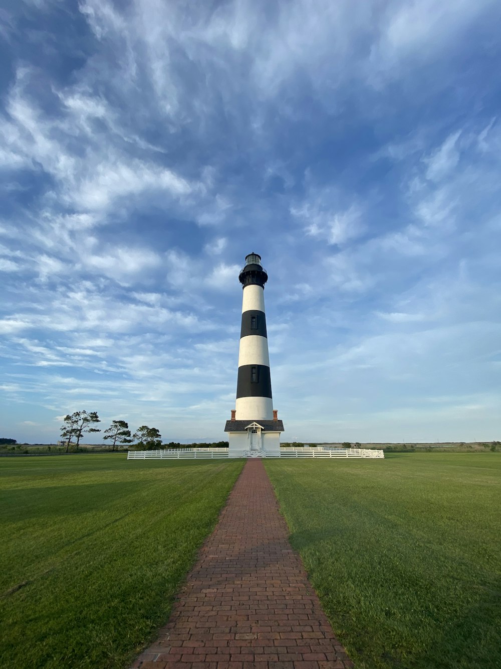 white and black lighthouse under blue sky during daytime