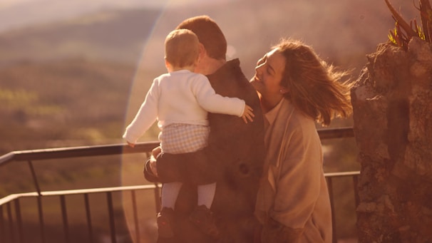 Family members sharing a quiet moment with a loved one in a peaceful garden setting.
