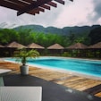 swimming pool near green mountain during daytime