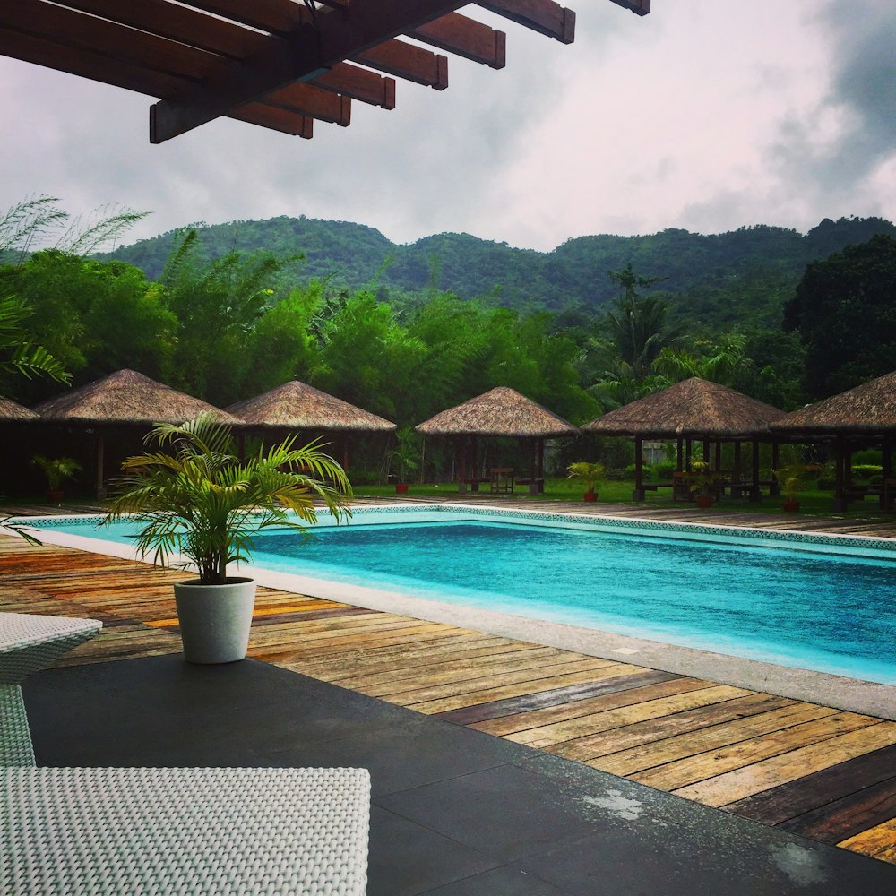 swimming pool near green mountain during daytime