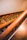 Close-up of a warmly stained wooden staircase with polished handrails inside a cozy home