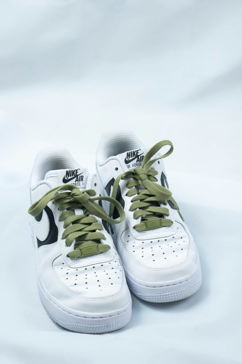 white and green nike athletic shoes
