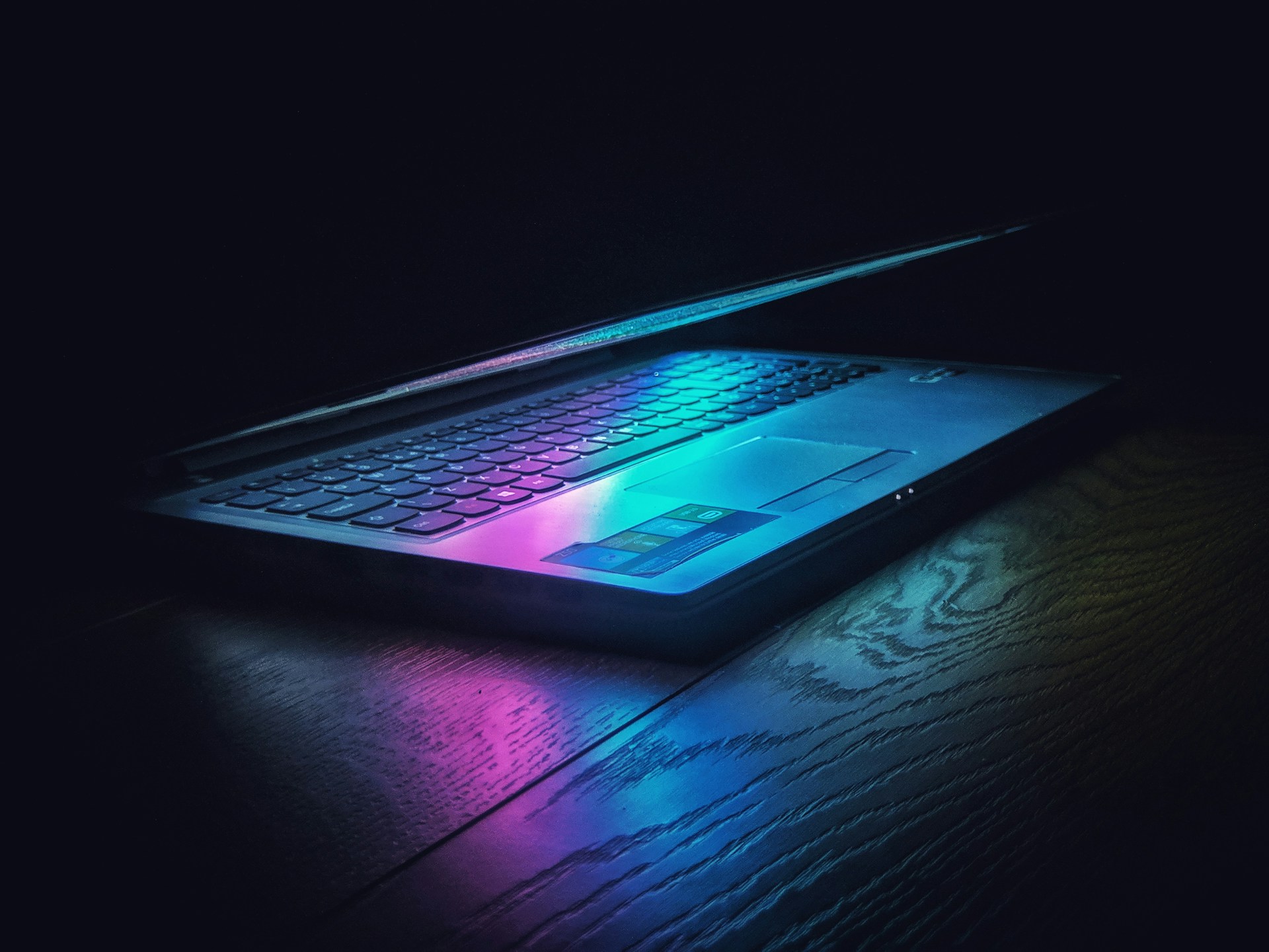black laptop computer on black and white floral textile