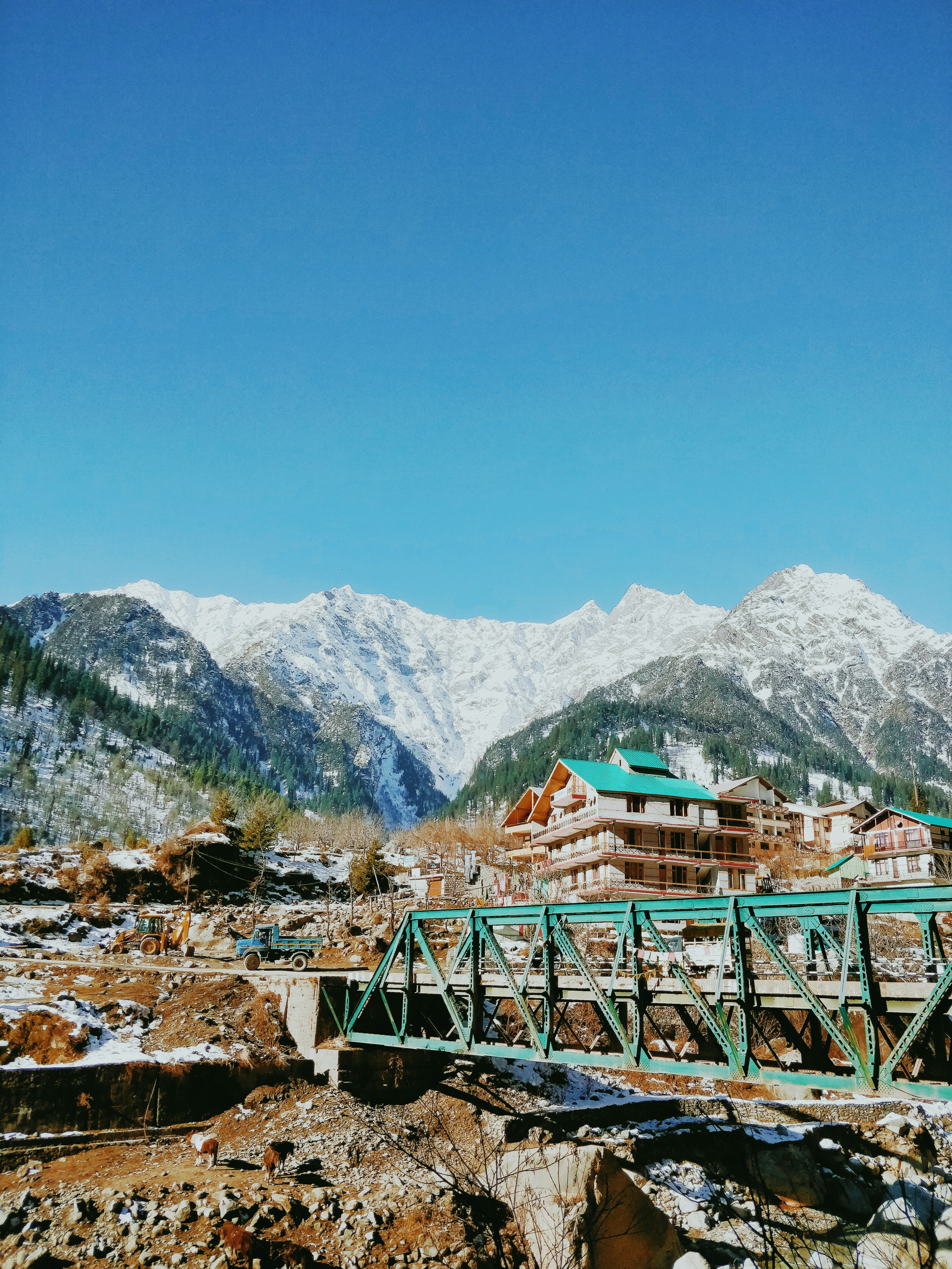 green wooden bridge over the mountains during daytime