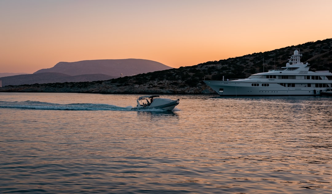 white and blue boat on sea during daytime