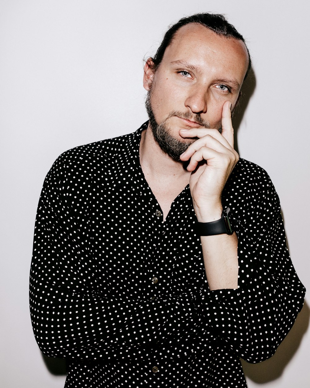 man in black and white polka dot dress shirt