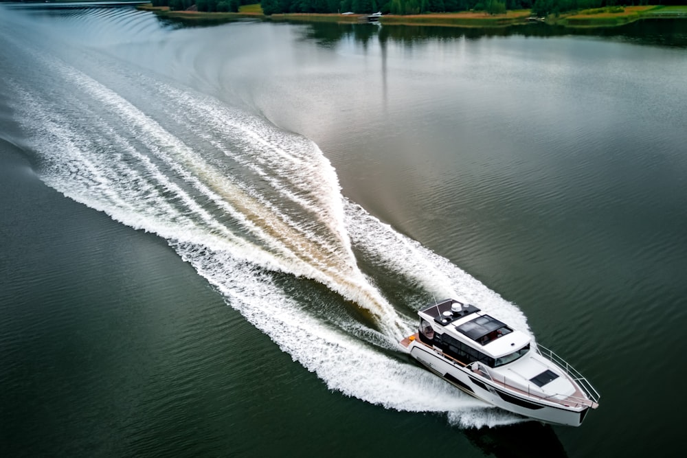 white and black boat on water during daytime