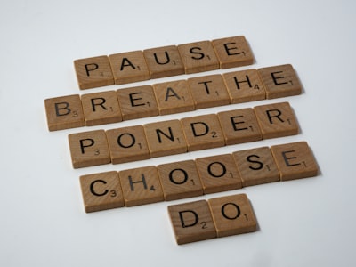 scrabble pieces spelling pause, breathe, ponder, choose and do
