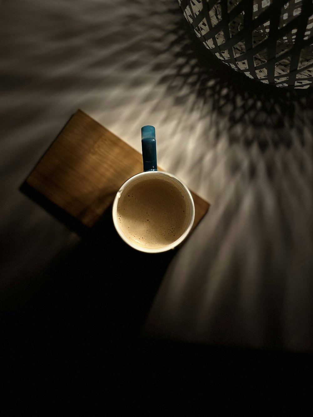 white ceramic mug on brown wooden table