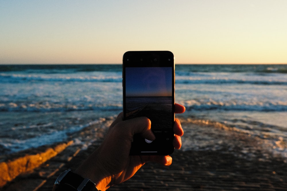 person holding black iphone 5