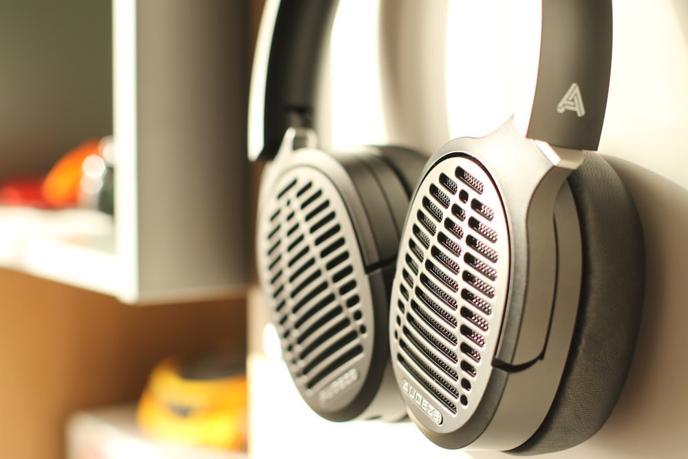 white and black headphones on brown wooden table