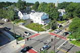 A panoramic view of a quiet neighborhood with several houses and tree-lined streets.