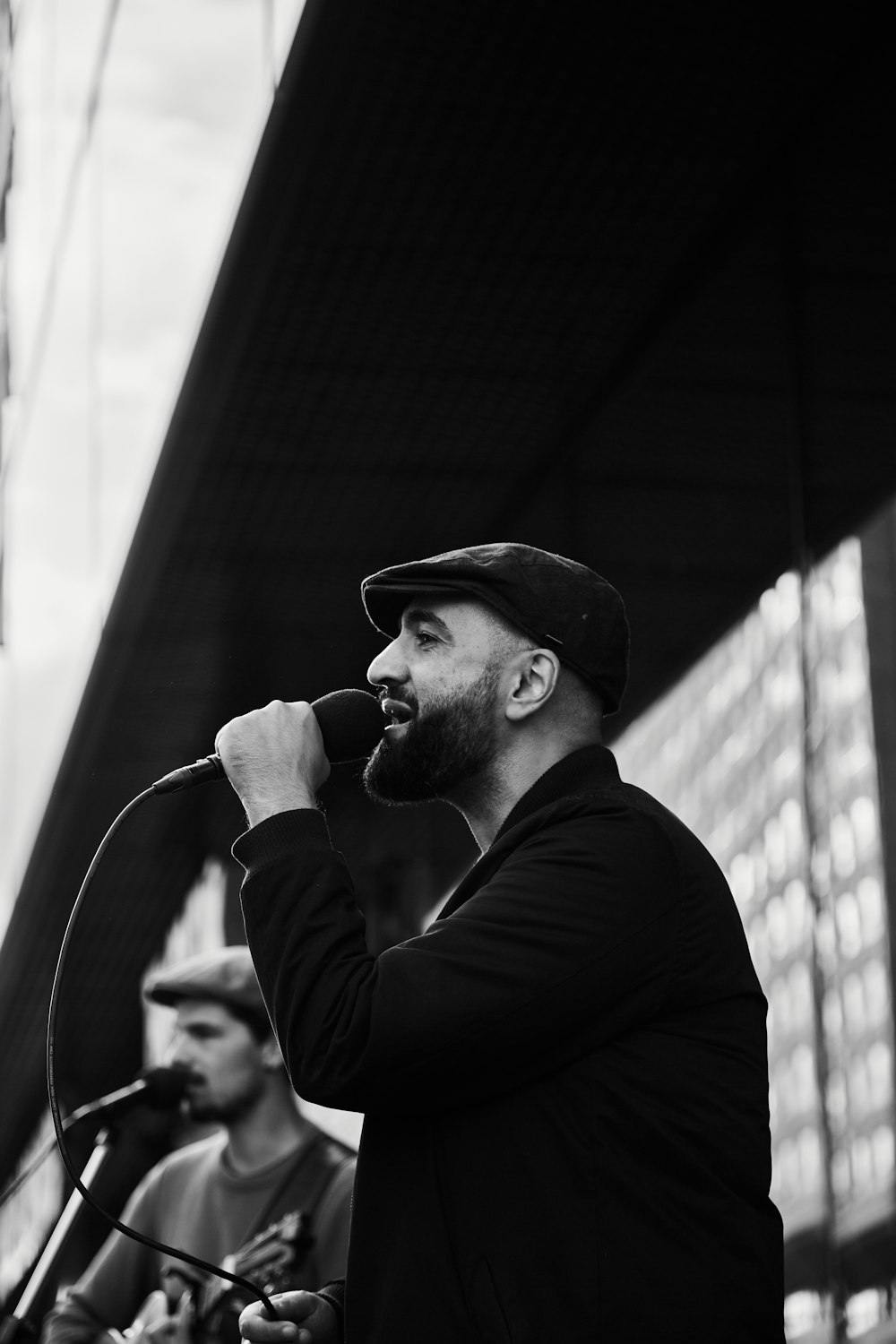 man in black long sleeve shirt singing