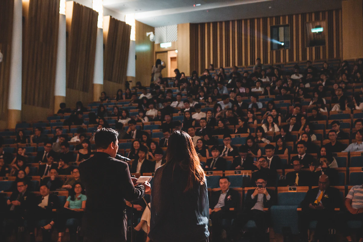 Conference attendees seated in a session hall