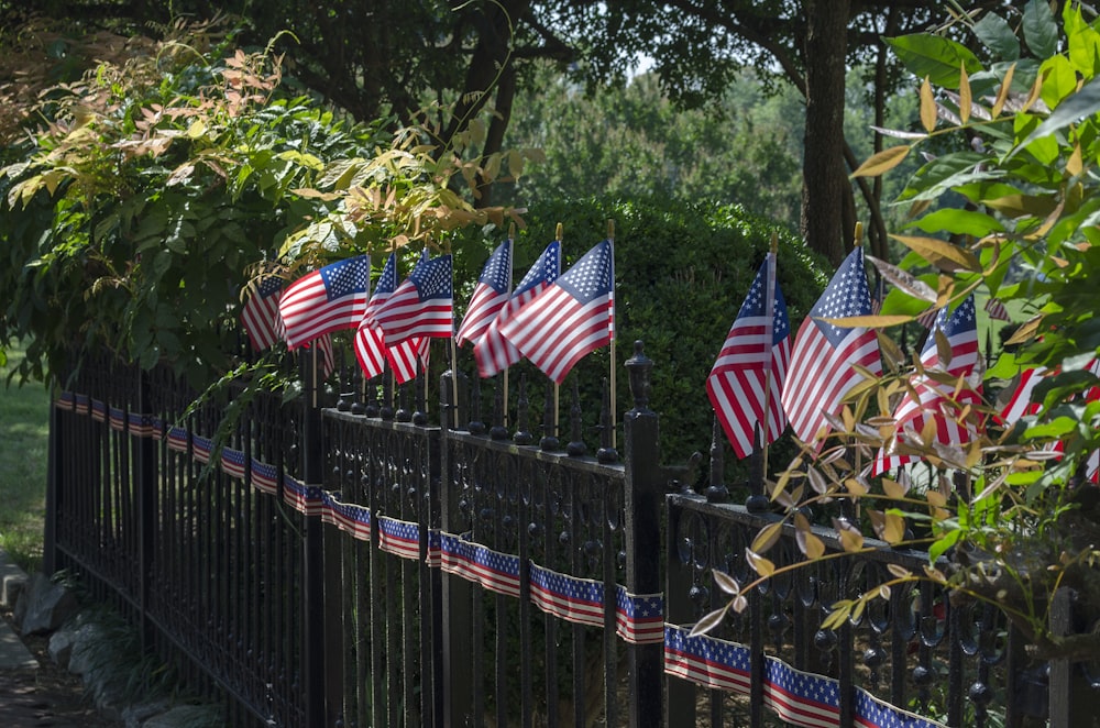 us a flags on black metal fence