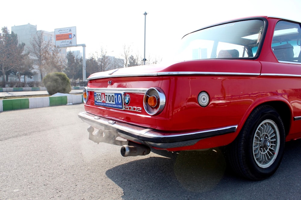 red classic car on road during daytime