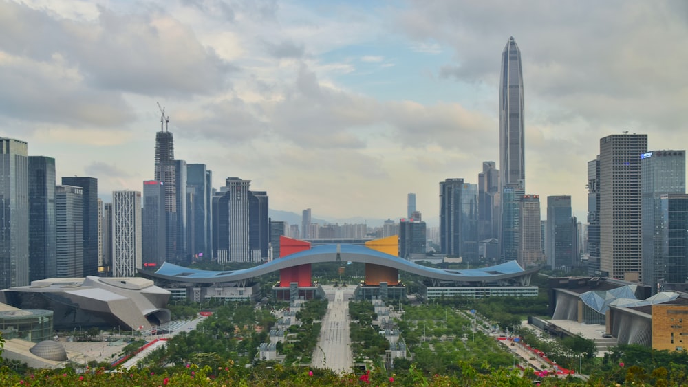 high rise buildings near green trees and body of water during daytime