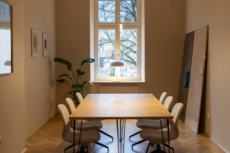 Modern minimalist wooden dining table with sleek chairs in a bright room