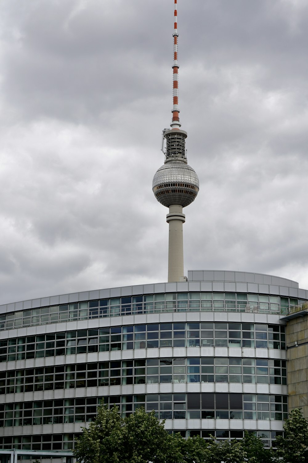 white and red tower under cloudy sky during daytime