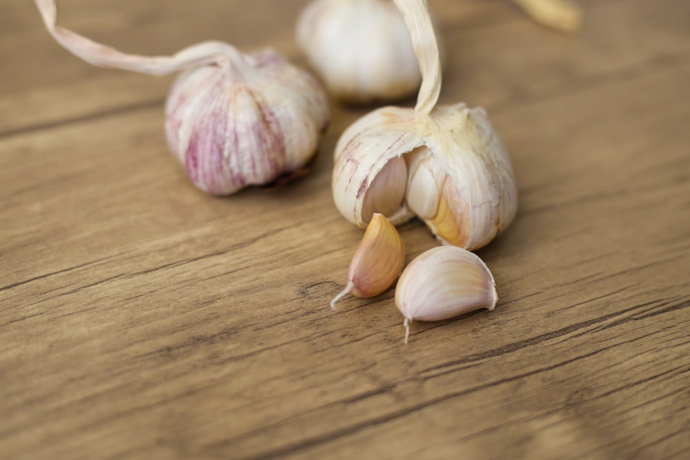 garlic on brown wooden table