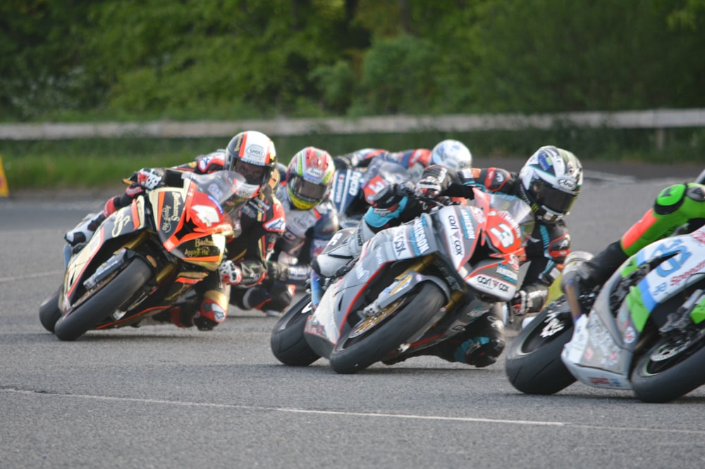 man in blue and white motorcycle suit riding on sports bike