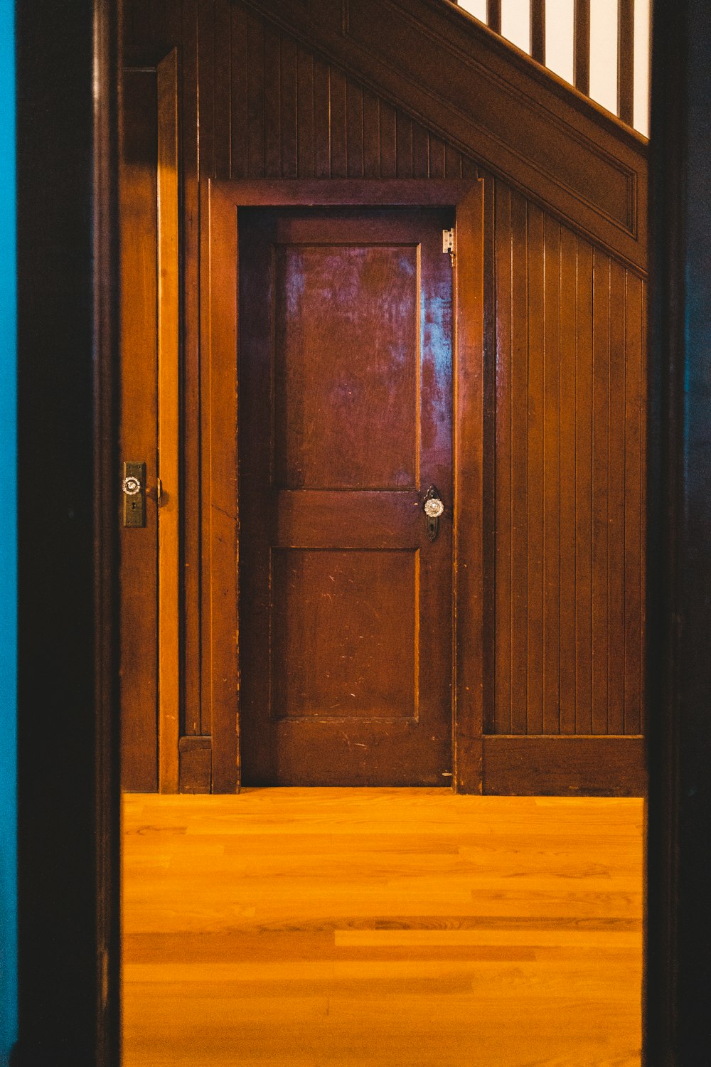 brown wooden door with black door lever