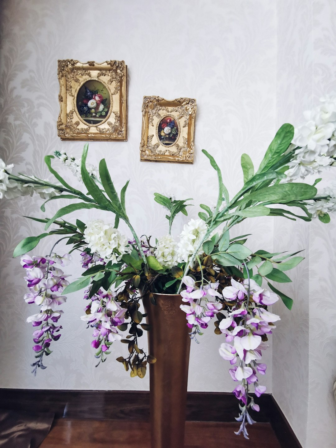 purple and white flower in brown vase