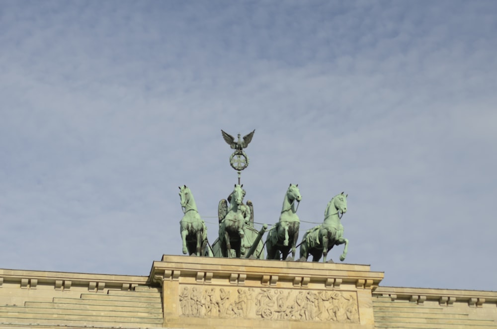 man riding horse statue under gray sky