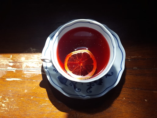 red liquid in clear drinking glass