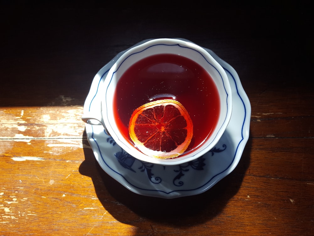 red liquid in clear drinking glass