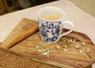 white ceramic mug on brown wooden table