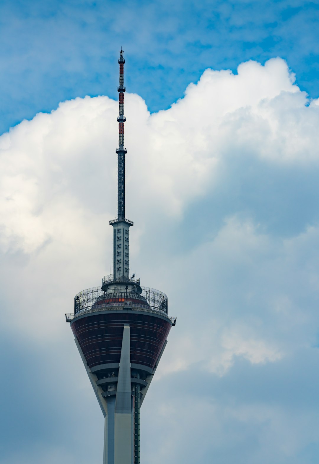 black and white tower under blue sky and white clouds during daytime