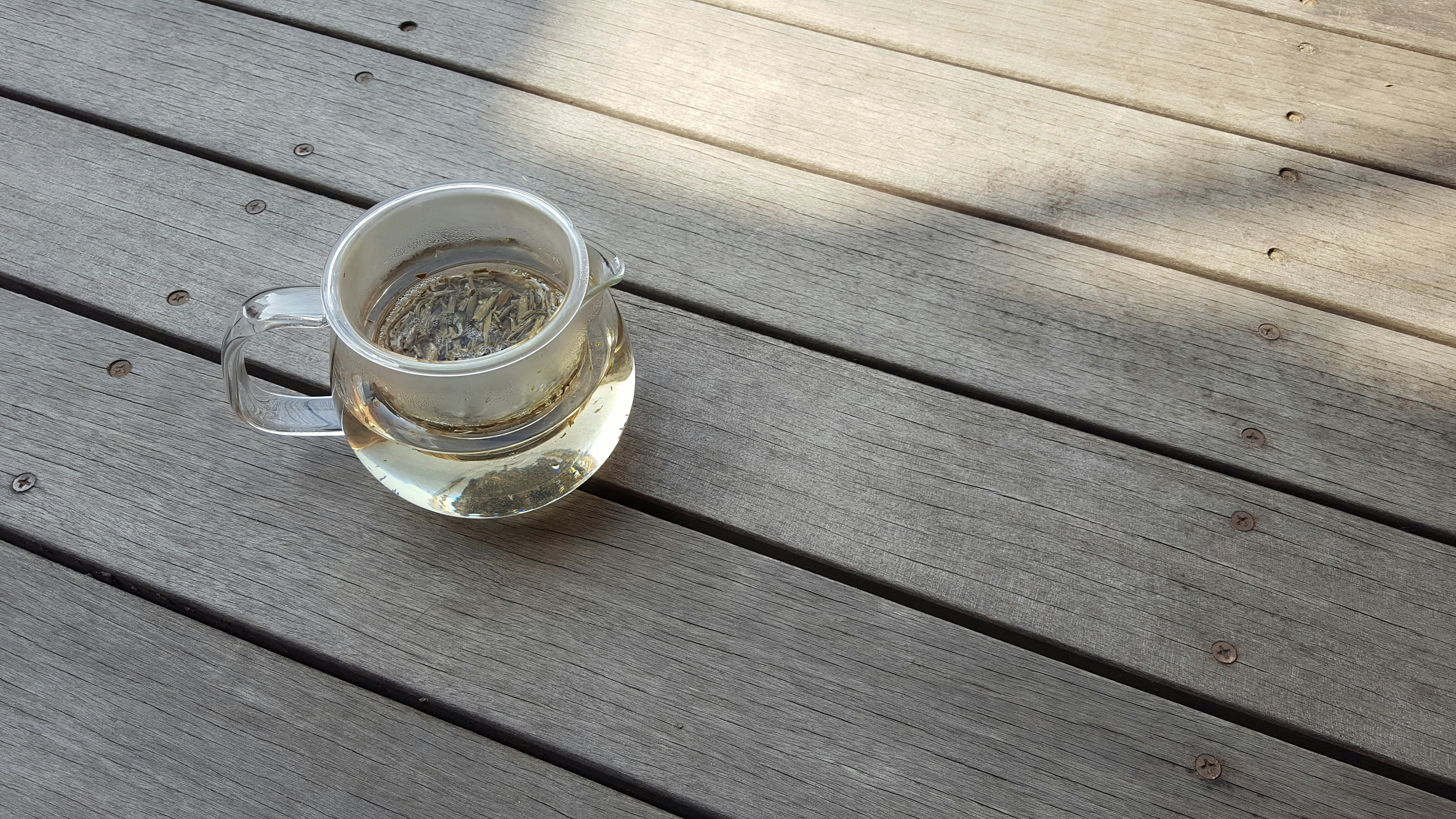 clear glass mug on brown wooden table
