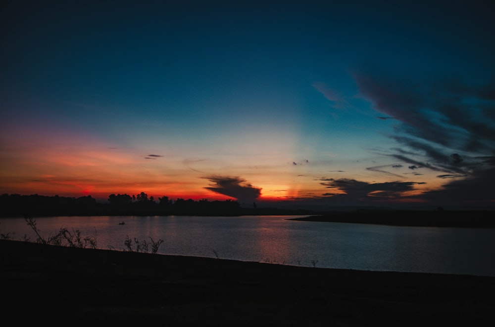 body of water during sunset