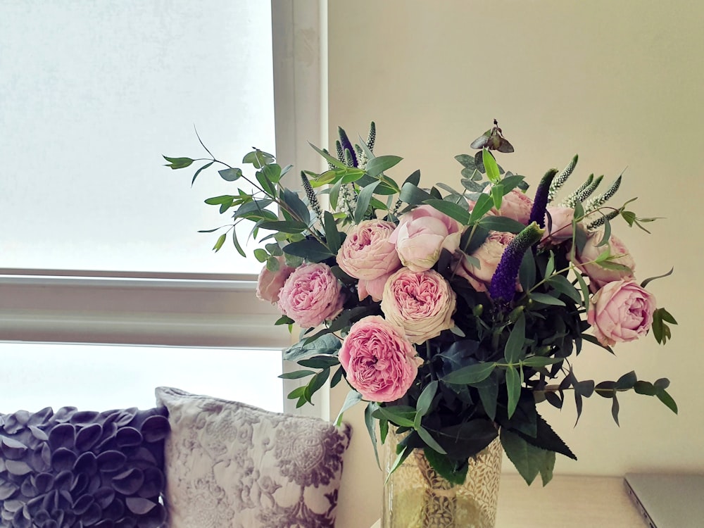 pink roses in clear glass vase