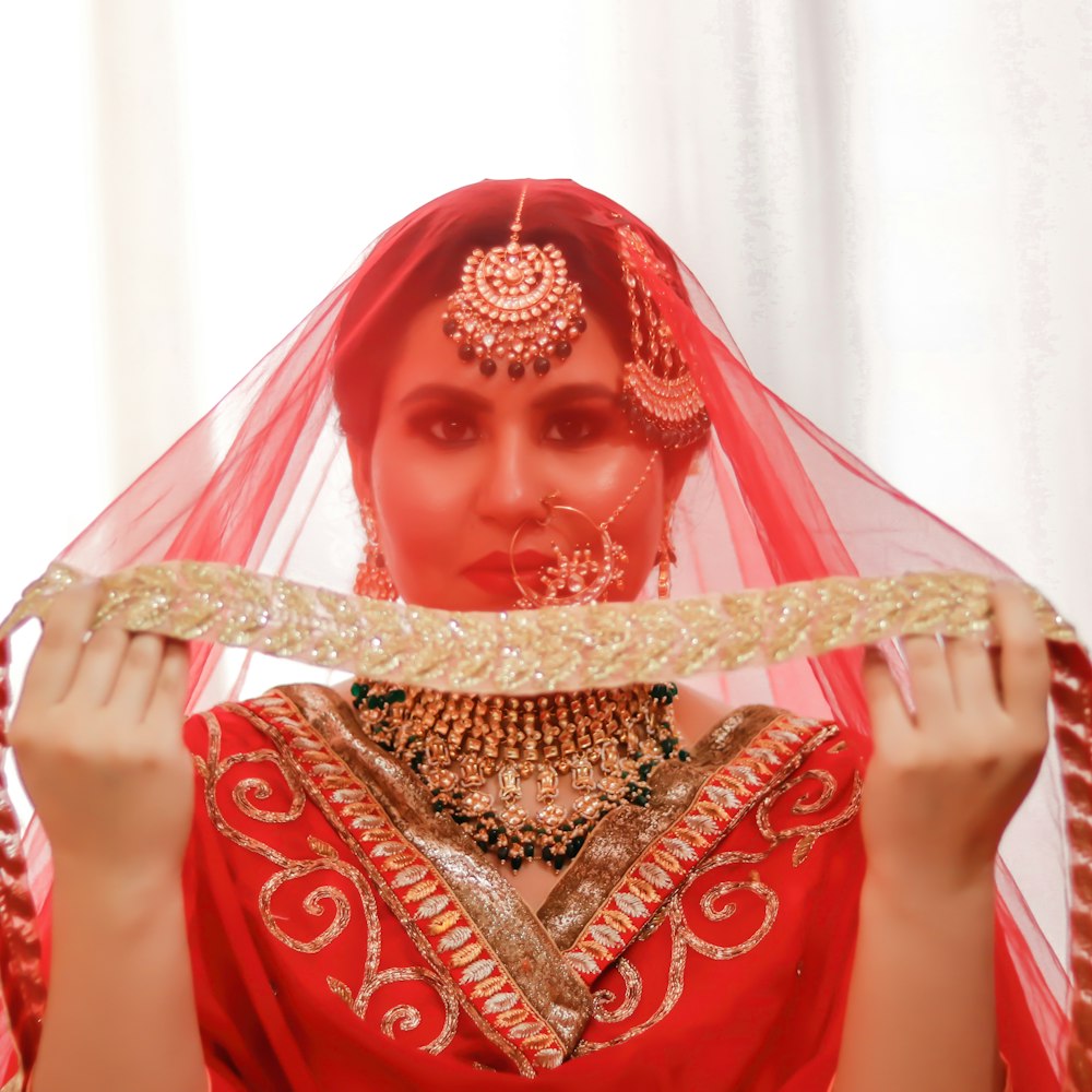 woman in red and gold sari