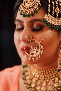 woman with green and gold earrings