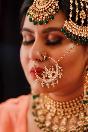 woman with green and gold earrings