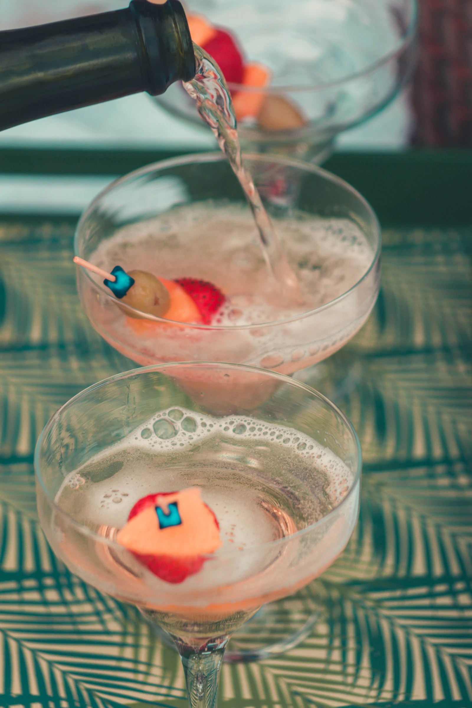 Clear drinking glass with red liquid and ice