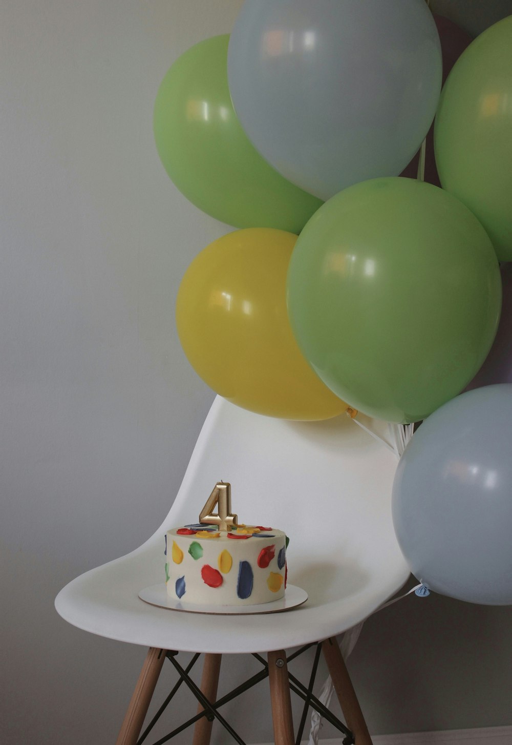 green blue and white balloons on white ceramic pot