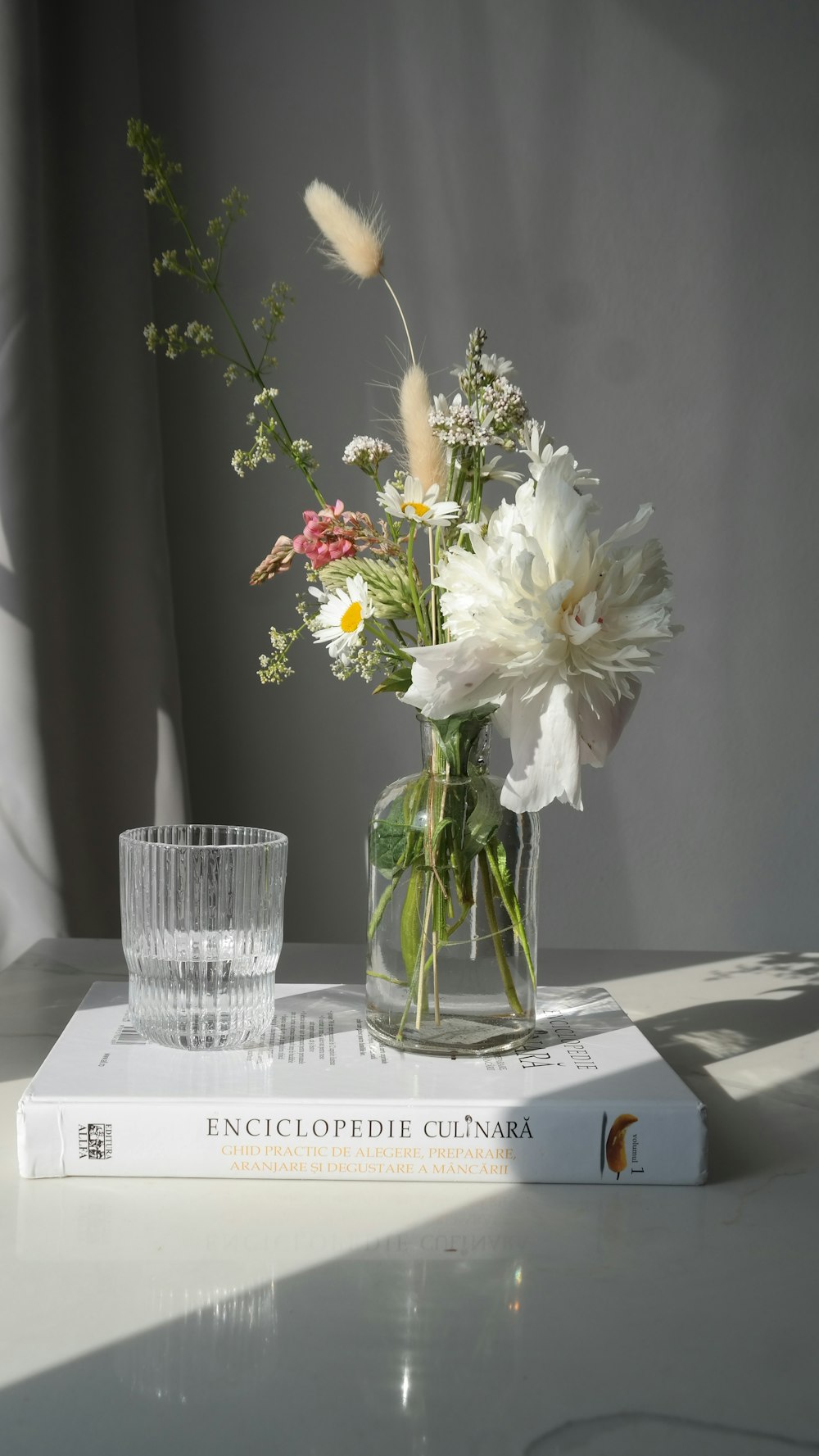 white flowers in clear glass vase