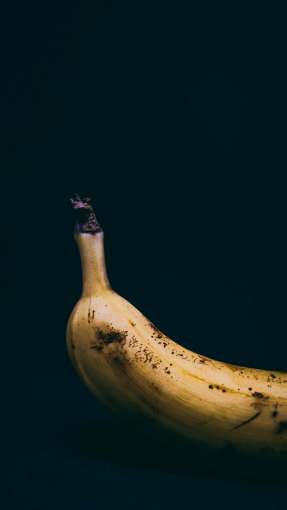 yellow banana on black surface